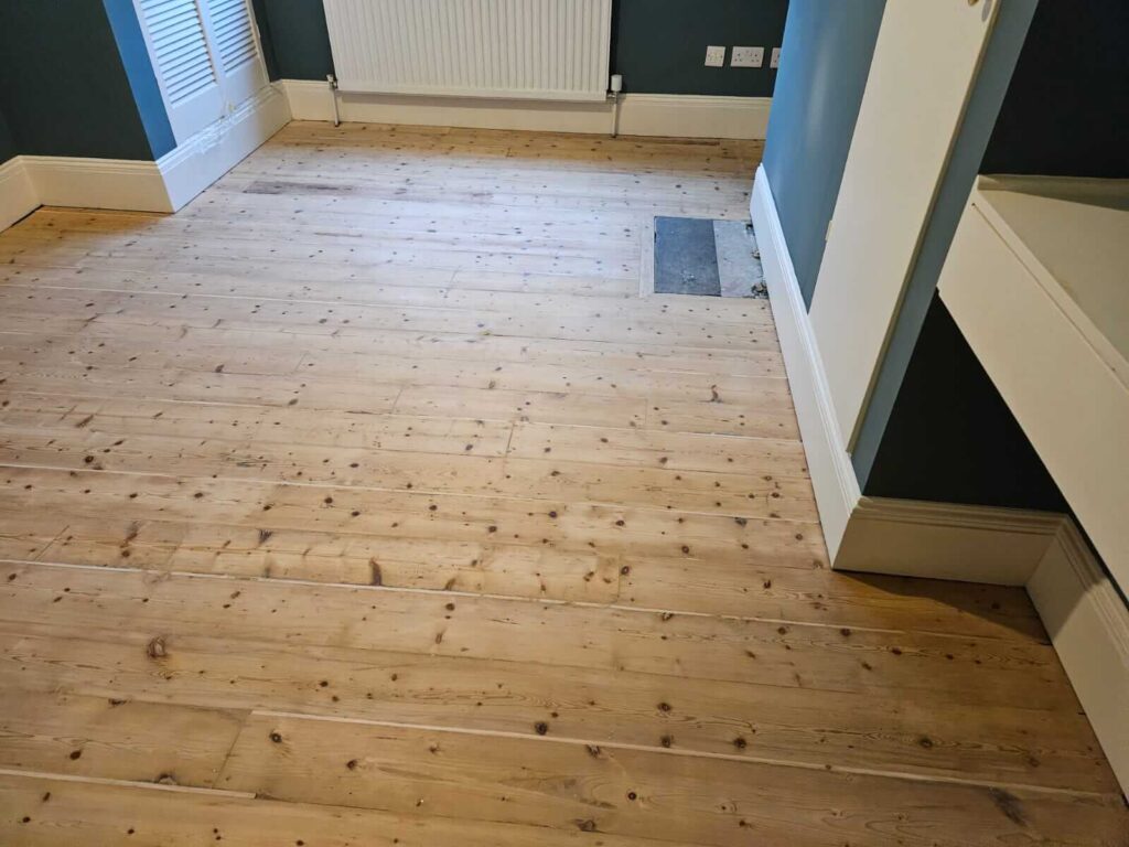 Dustless floor sanding machine restoring a wooden floor in London